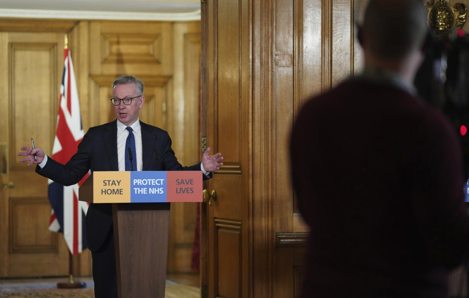 In this image made available by British government because no media allowed into 10 Downing Street because of the coronavirus pandemic, showing British lawmaker Michael Gove holding a Digital Press Conference on COVID-19, in 10 Downing Street, London, Friday March 27, 2020. Prime Minister Boris Johnson tested positive for the COVID-19 coronavirus Friday along with other members of the government, and has self isolated. (Pippa Fowles / No 10 Downing Street via AP)