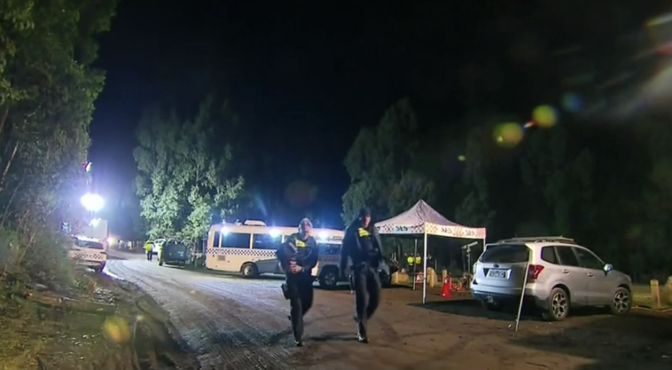 Police and SES continued to search for William Callaghan overnight. Pictured is the search party at the scene in Victoria.