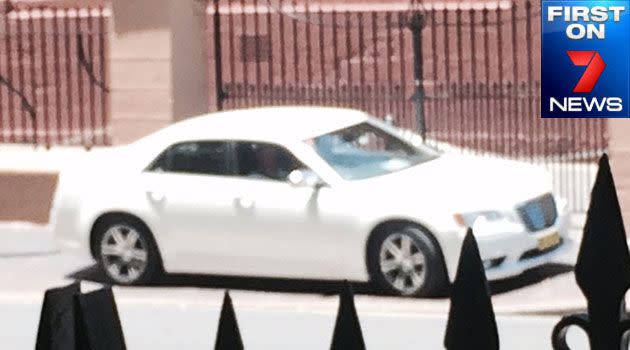 Tense standoff: A man refuses to get out of a white sedan parked outside NSW Parliament House. Photo: FIRST ON 7