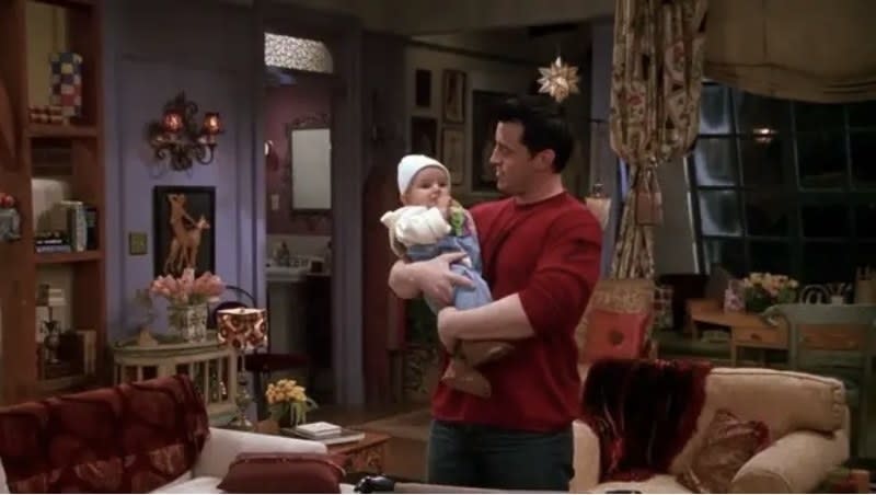 Joey holding a baby