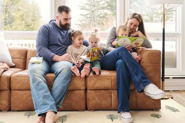 <p>courtesy of Pottery Barn Kids</p> Jason Kelce reading with daughters Wyatt and Elliotte while Kylie Kelce reads with daughter Bennett