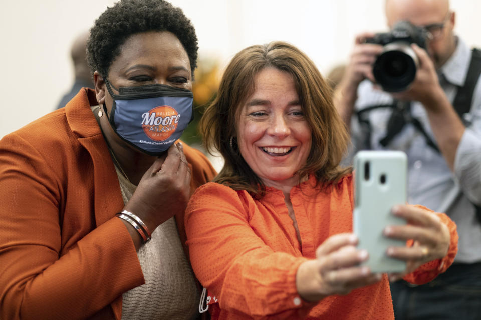 Felicia Moore, Atlanta City Council president and mayoral candidate, left, takes a selfie with supporter Heidi Oquendo at her election night party Tuesday, Nov. 2, 2021 in Atlanta. (AP Photo/Ben Gray)