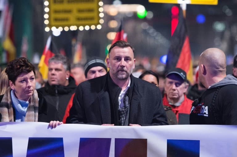 Lutz Bachmann (C), leader of the PEGIDA movement attends a protest rally on December 7, 2015 in Dresden, eastern Germany