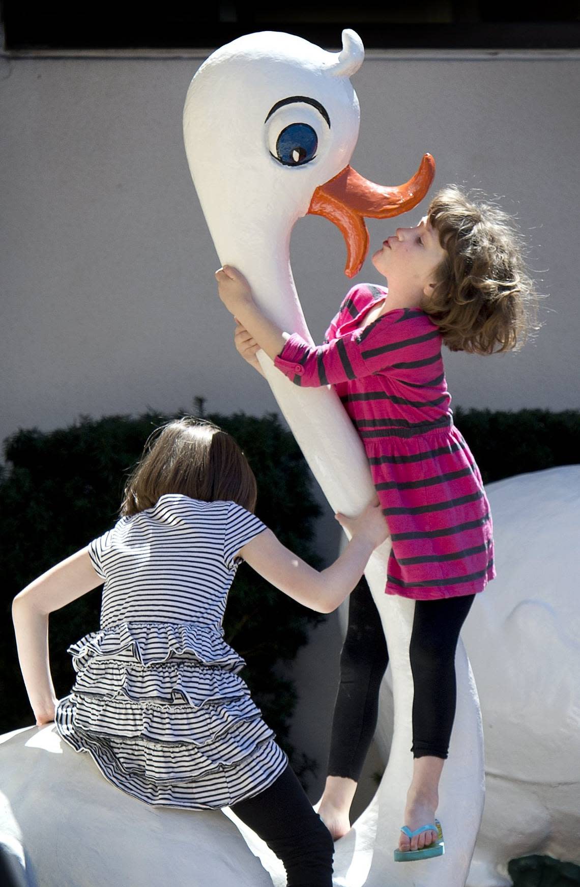 Swans on the Country Club Plaza caught the attention of Bella Myers (right), 5, and her sister, Elizabeth Myers, 7, as they enjoyed their first day of Spring break on Monday, March 30, 2015. The swans are a part of the Wonderland Animals, which have accompanied the Plaza Easter bunnies since the 1970s. Keith Myers/The Kansas City Star