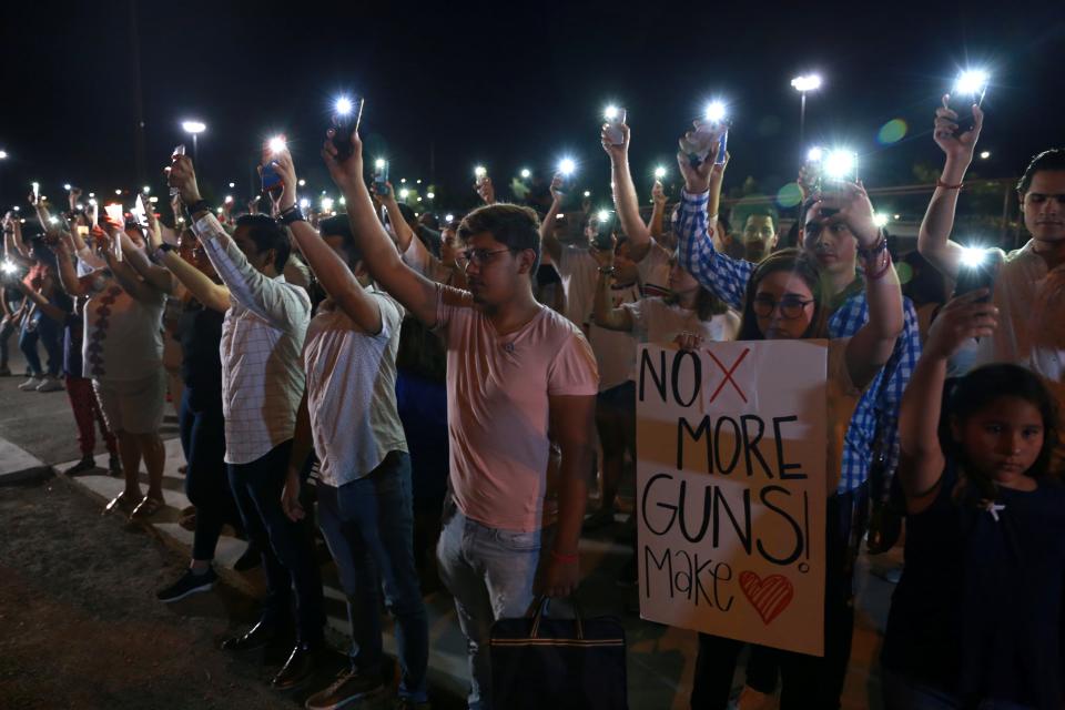 Mourners take part in a vigil near the border fence between Mexico and the U.S after a mass shooting at a Walmart store in El Paso U.S. in Ciudad Juarez. August 3, 2019. REUTERS/Carlos Sanchez