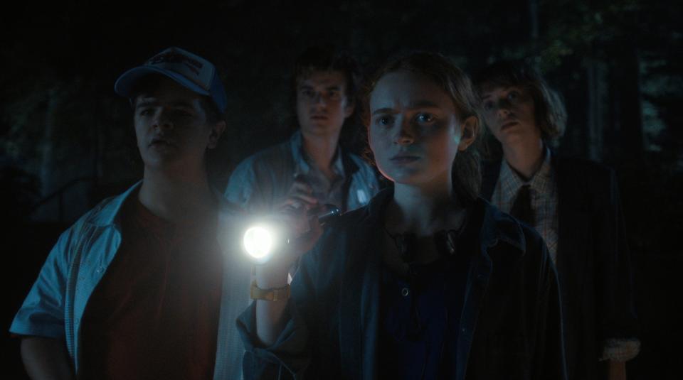 Sadie Sink as Max stands with the guys outside