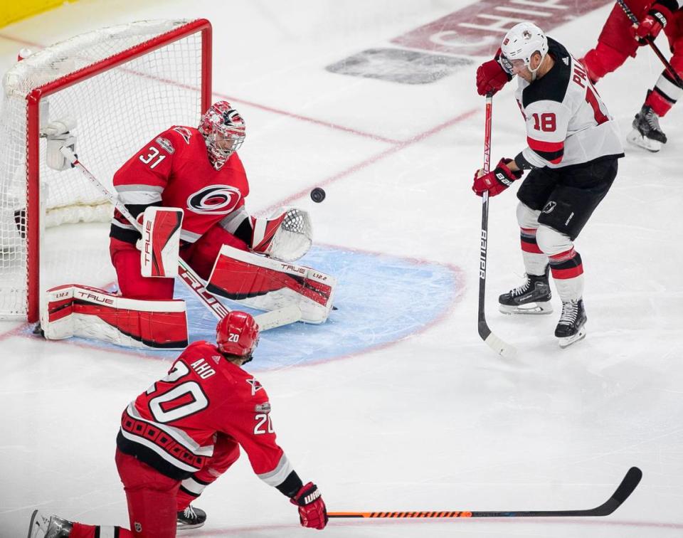 Carolina Hurricanes goalie Frederik Andersen (31) deflects a scoring attempt by the New Jersey Devils Ondrej Palat (18) in overtime during Game 5 of their second round Stanley Cup playoff series on Thursday, May 11, 2023 at PNC Arena in Raleigh, N.C. Andersen made 27 saves in the Hurricanes’ 3-2 overtime victory.