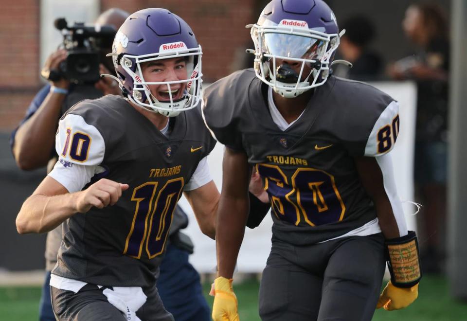 Northwestern quarterback Finley Polk (10) and Kameron Vance celebrate after Vance scores a touchdown Friday, Aug. 11, 2023.