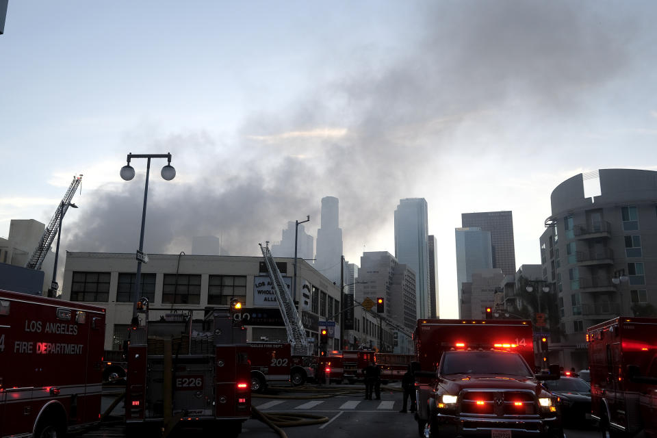 Smoke rises from the scene of a structure fire that injured multiple firefighters, according to a fire department spokesman, Saturday, May 16, 2020, in Los Angeles. (AP Photo/Ringo H.W. Chiu)