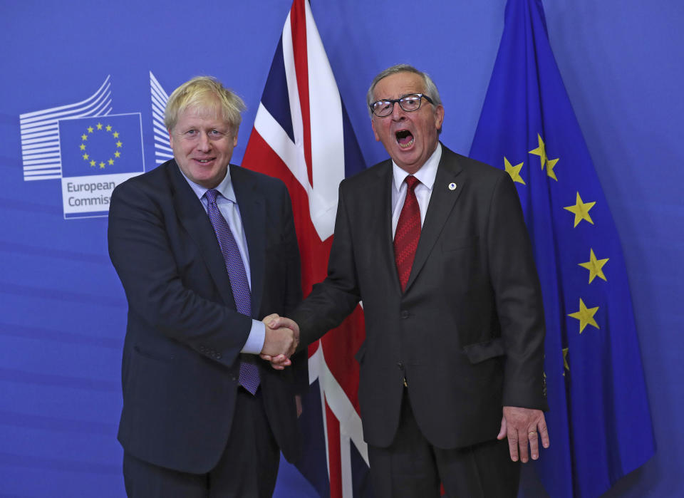 FILE - British Prime Minister Boris Johnson shakes hands with European Commission President Jean-Claude Juncker during a press point at EU headquarters in Brussels, Thursday, Oct. 17, 2019. British media say Prime Minister Boris Johnson has agreed to resign on Thursday, July 7 2022, ending an unprecedented political crisis over his future. (AP Photo/Francisco Seco, File)