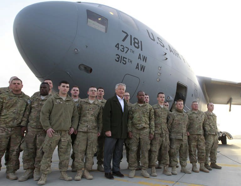 US Secretary of Defense Chuck Hagel (centre) poses for a picture with US troops at Kabul airport on March 11, 2013 before boarding a flight back to Washington. The US commander in Afghanistan has warned troops that they face an increased threat of attack after a series of inflammatory anti-US comments by President Hamid Karzai