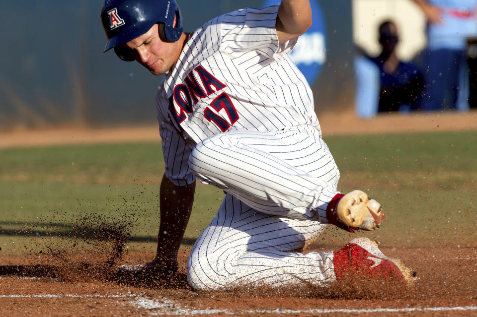 Arizona first baseman Branden Boissiere (17) slides in to home plate against Mississippi during an NCAA college baseball super regional game Sunday, June 13, 2021, in Tucson, Ariz. (Rebecca Sasnett/Arizona Daily Star via AP)