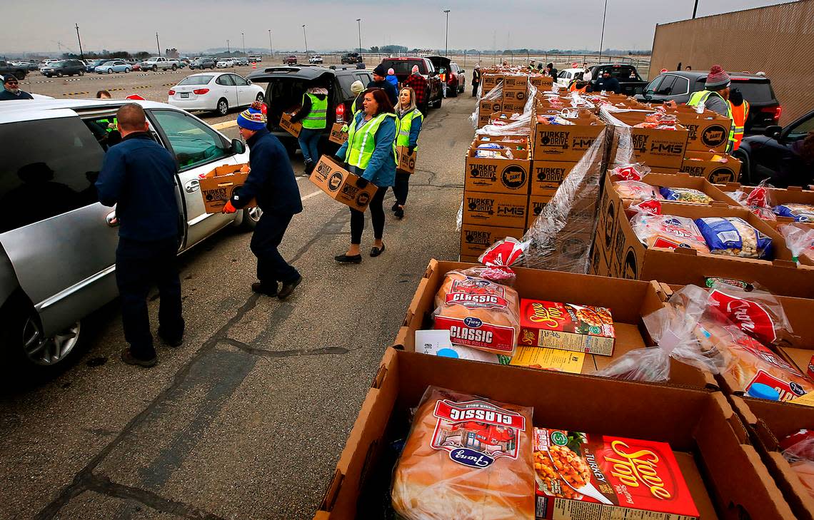 Several dozen community volunteers team up to help distribute 1,000 Thanksgiving meal boxes at the Benton County Fairgrounds in Kennewick during Second Harvest’s 7th annual Turkey Drive event in 2022.
