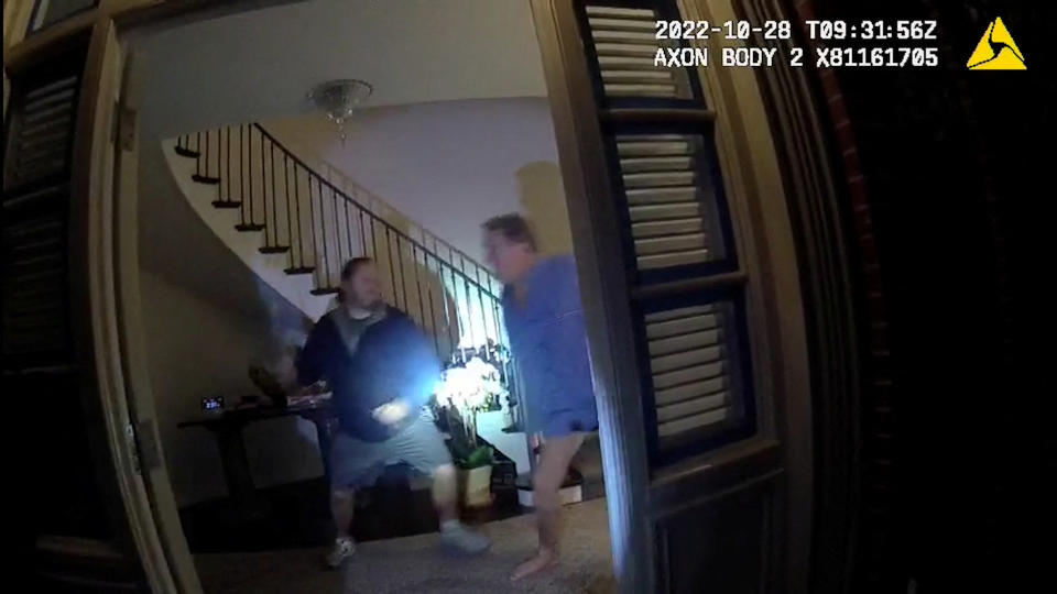 A screenshot from police body camera video shows David DePape wielding a hammer before striking Paul Pelosi with it inside Pelosi's San Francisco home on Oct. 28. 