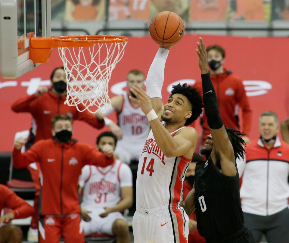 Ohio State Buckeyes forward Justice Sueing (14) goes up for a shot while guarded by Michigan State Spartans forward Aaron Henry (0) during Sunday's NCAA Division I men's basketball game at Value City Arena in Columbus, Ohio on January 31, 2021. Ohio State won the game 79-62.