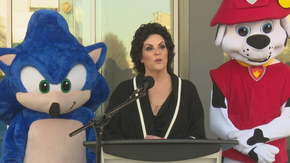 Downtown Windsor BIA executive director Debi Croucher announces the return of the Canada Day parade to downtown Windsor flanked by Paw Patrol and Sonic the Hedgehog who will be costumed characters in the parade.