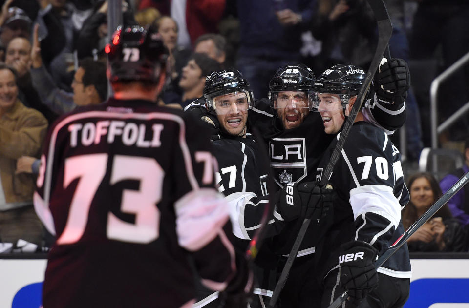 Los Angeles Kings center Jarret Stoll, second from right, celebrates his goal with center Tyler Toffoli, left, defenseman Alec Martinez, second from left, and left wing Tanner Pearson during the second period in Game 3 of an NHL hockey first-round playoff series against the San Jose Sharks, Tuesday, April 22, 2014, in Los Angeles. (AP Photo/Mark J. Terrill)