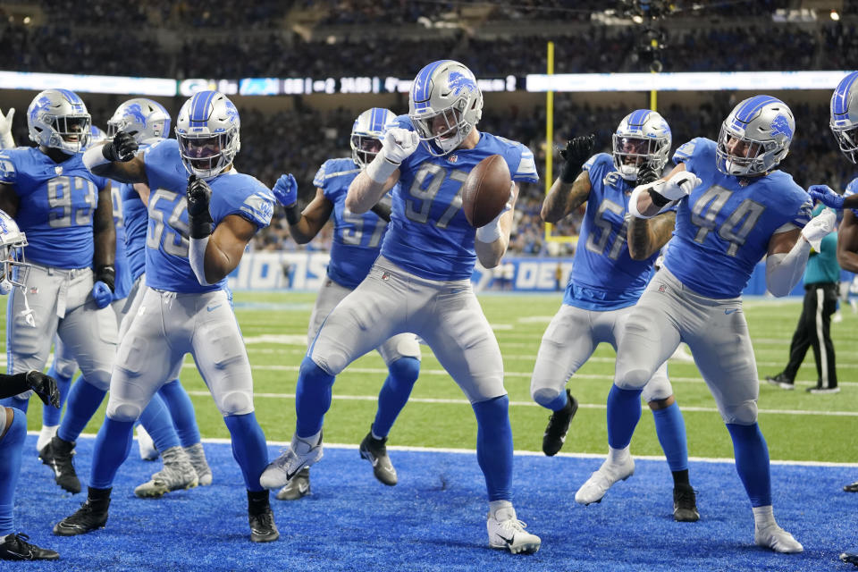 Detroit Lions defensive end Aidan Hutchinson (97) reacts after intercepting a pass intended for Green Bay Packers wide receiver Allen Lazard during the first half of an NFL football game, Sunday, Nov. 6, 2022, in Detroit. (AP Photo/Paul Sancya)