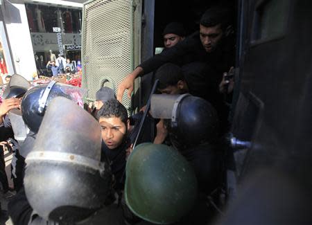 Riot police detain a man, who was protesting against a new law restricting demonstrations, in downtown Cairo November 26, 2013. REUTERS/Amr Abdallah Dalsh