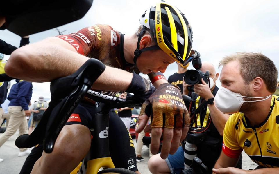 Jumbo-Visma team's Danish rider Jonas Vingegaard reacts with teammates after winning the 11th stage - AFP