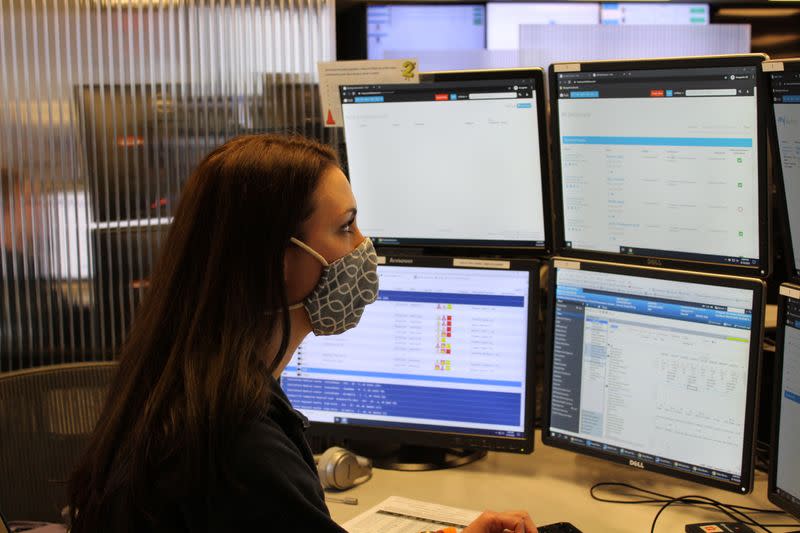 Emily Lardinois, a critical-care nurse, monitors intensive-care patients across the United States remotely from Advanced ICU Care's operations center in St. Louis