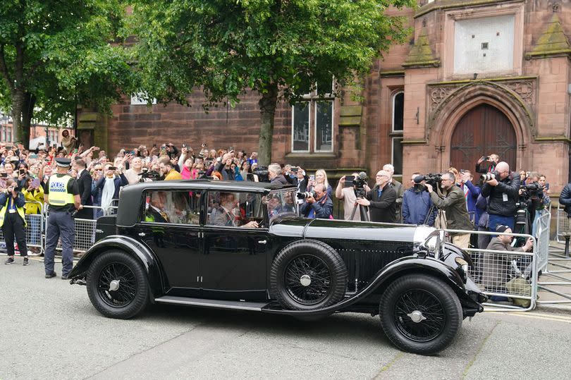The couple in a vintage Bentley leave the ceremony -Credit:PA