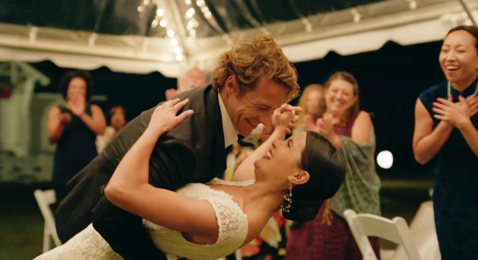 A married couple dances at their wedding.