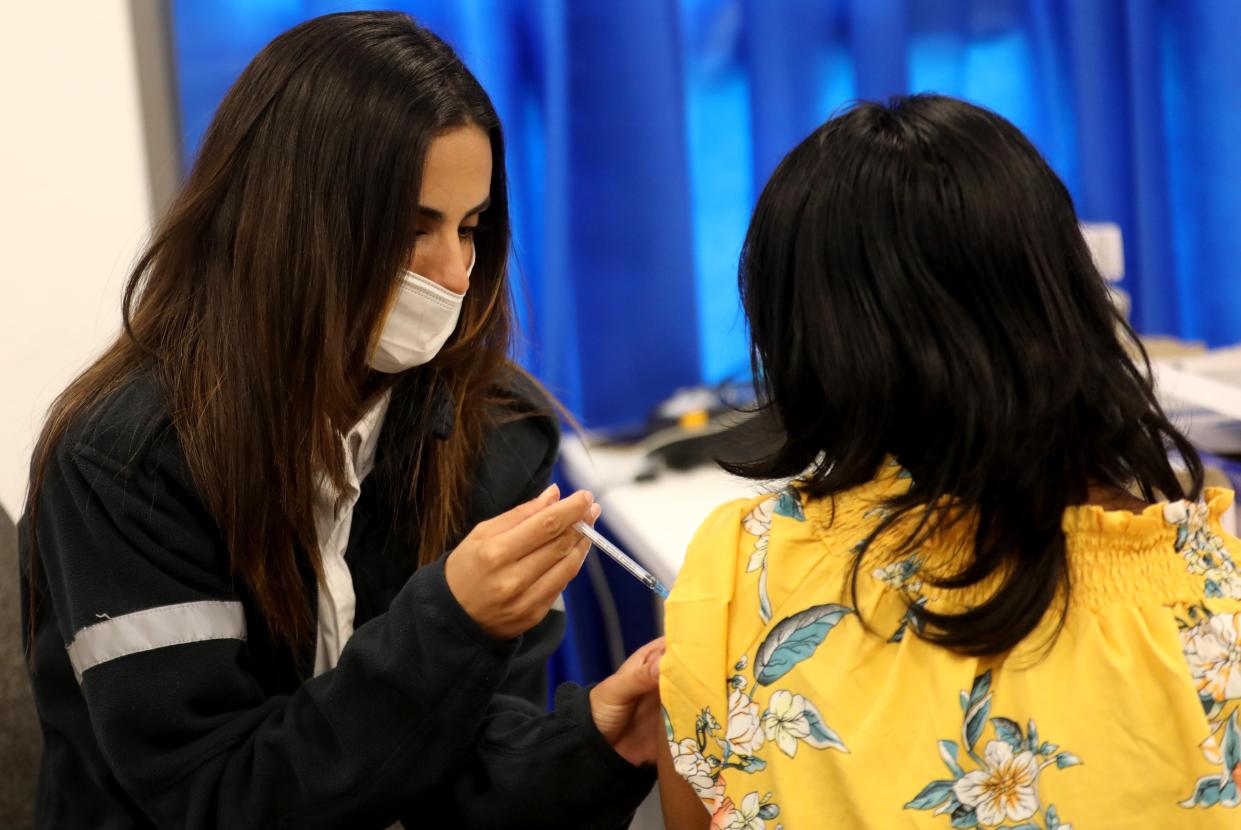 A woman receives the COVID-19 vaccine in the Israeli city of Modi'in.