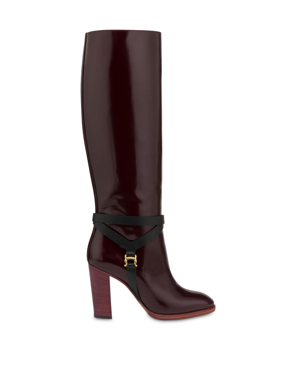 Pollini’s Cavaliere boot in a glossy burgundy leather with a stacked heel, part of its 70th anniversary capsule for its Pollini Archive line. - Credit: Courtesy of Pollini
