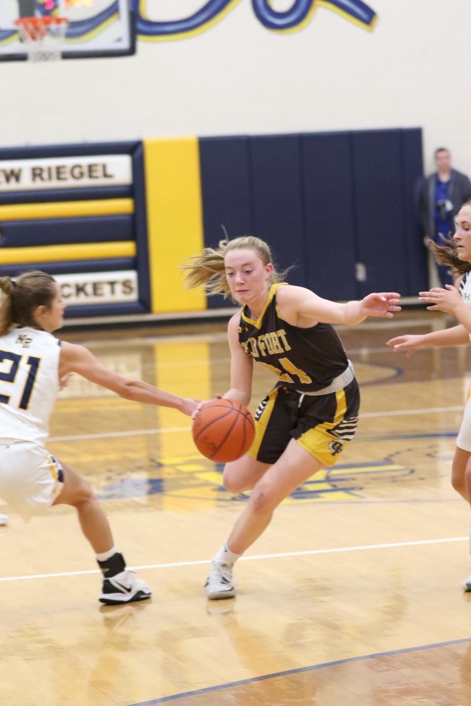 Old Fort's Addy Gillmor splits two defenders.