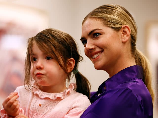 <p>Rich Schultz/Getty</p> Kate Upton holds her daughter Genevieve Upton Verlander during a press conference at Citi Field in 2022.