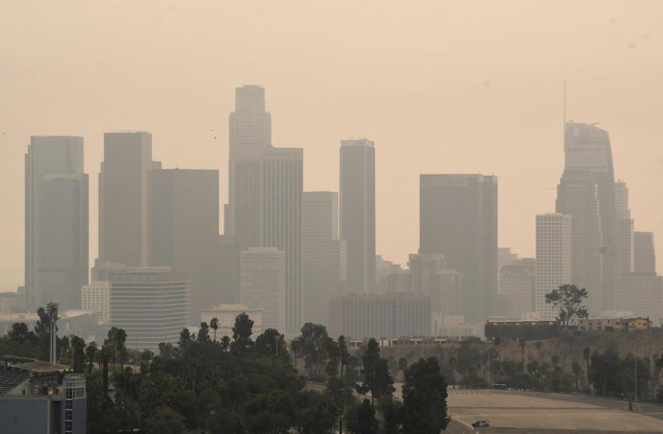Downtown Los Angeles and Dodger Stadium are shrouded, looking south from Elysian Fields through the smoke from the Bobcat and the El Dorado fires, Friday, Sept. 11, 2020. (Keith Birmingham/The Orange County Register via AP)