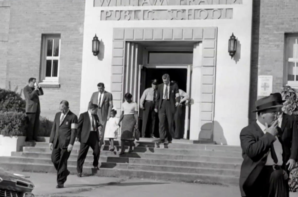Federal marshals escort Ruby Bridges outside her school in 1960. She said she was so excited for school because she wanted to make friends; but when she got there, the classroom was empty. (TODAY)