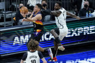 Phoenix Suns guard Devin Booker slips past Brooklyn Nets forward Jeff Green, right, during the first half of an NBA basketball game, Tuesday, Feb. 16, 2021, in Phoenix.(AP Photo/Matt York)