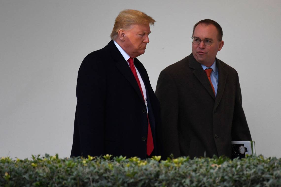 In this January 2020 photo, then-Acting White House Chief of Staff Mick Mulvaney and President Donald Trump walk along the colonnade at the White House in Washington, D.C.