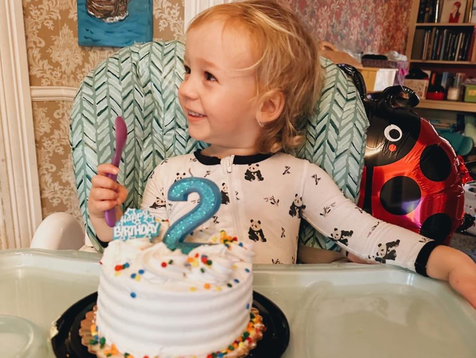 A two-year-old with his birthday cake