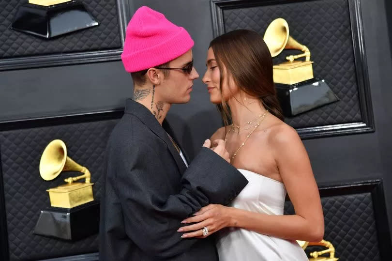 Justin and Hailey Bieber embrace at Grammy red carpet