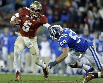 FILE - In this file photo from Dec. 7, 2013, Florida State&#39;s Jameis Winston (5) scrambles as Duke&#39;s Kelby Brown (59) defends in the first half of the Atlantic Coast Conference Championship NCAA football game in Charlotte, N.C. The No. 1-ranked Florida State held their final workout on campus Monday, Dec. 30 2013, before flying to California to face No. 2 Auburn in the BCS NCAA college football championship game. (AP Photo/Bob Leverone, file)