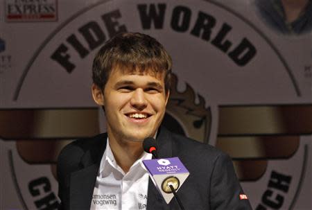 Norway's Magnus Carlsen smiles as he speaks with the media at a news conference after clinching the FIDE World Chess Championship in the southern Indian city of Chennai November 22, 2013. REUTERS/Babu