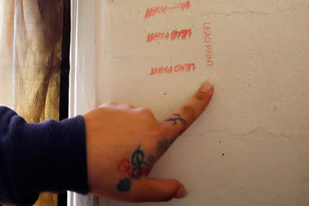 Natalia Rollins points to a spot on the wall of her children's bedroom where traces of lead were identified at her apartment in the Coney Island section of the Brooklyn borough of New York, U.S., October 27, 2017. REUTERS/Shannon Stapleton