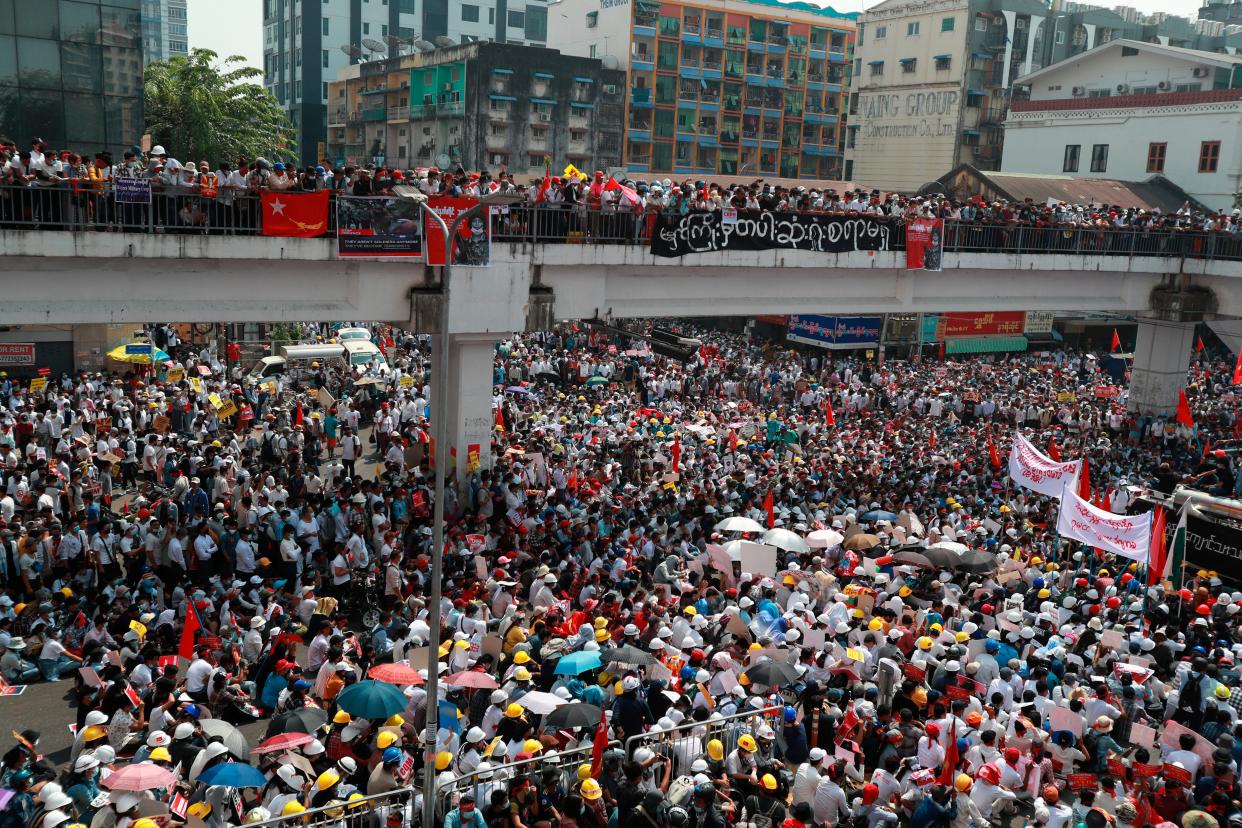 <p>Anti-coup protesters gather at an intersection in Myanmar’s biggest city, Yangon, on 22 February 2021</p> (AP)