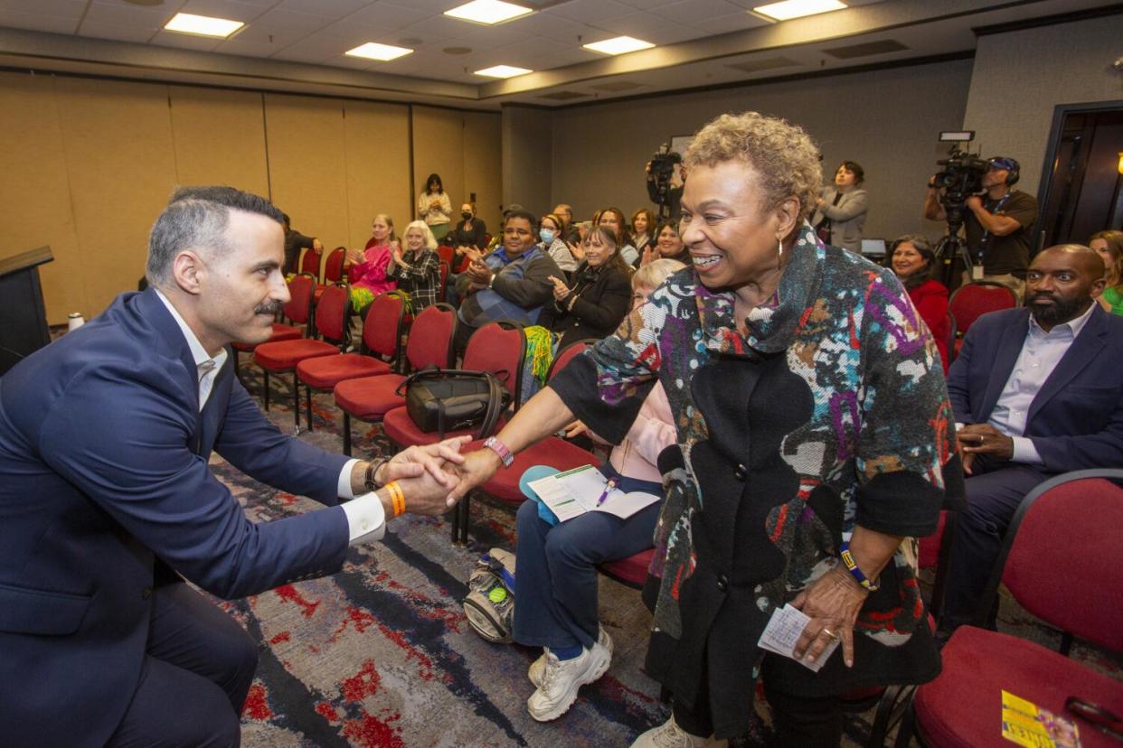 Rep. Barbara Lee shakes hand with a rally attendee.