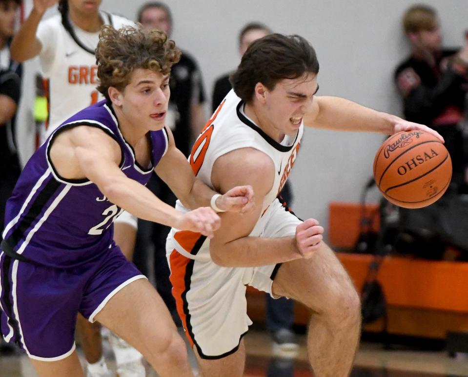 Jackson guard Anthony Fuline puts pressure on Green guard Brady Rollyson in the first quarter of Jackson at Green boys basketball. Friday, December 8, 2023.