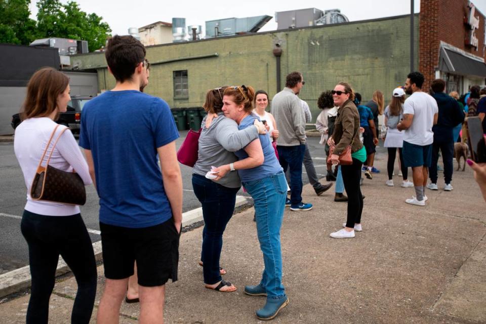 Co-owner Beverly Higgins hugs patrons that gathered around the corner of South Ashland and Main Street to try and purchase something on the last day of business for Magee’s Bakery in Lexington, Ky., Saturday, May 13, 2023. Some people waited in line over two hours.