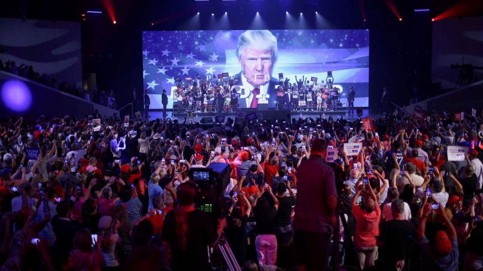 Republican presidential candidate and former President Donald Trump arrives to deliver a campaign speech during a Turning Point USA event at the Dream City Church in Phoenix