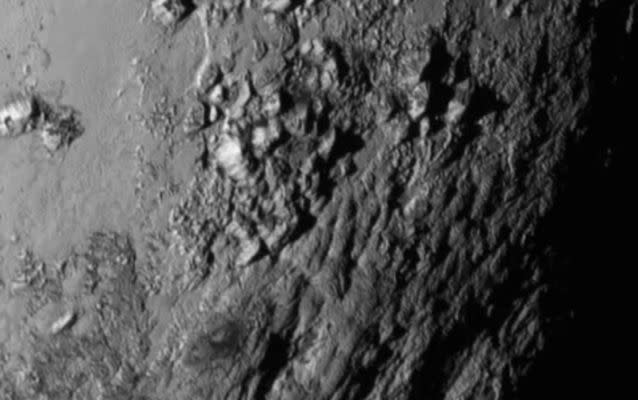 This image provided by NASA on Wednesday shows a region near Pluto's equator with a range of mountains captured by the New Horizons spacecraft. (NASASource: NASA/AP.