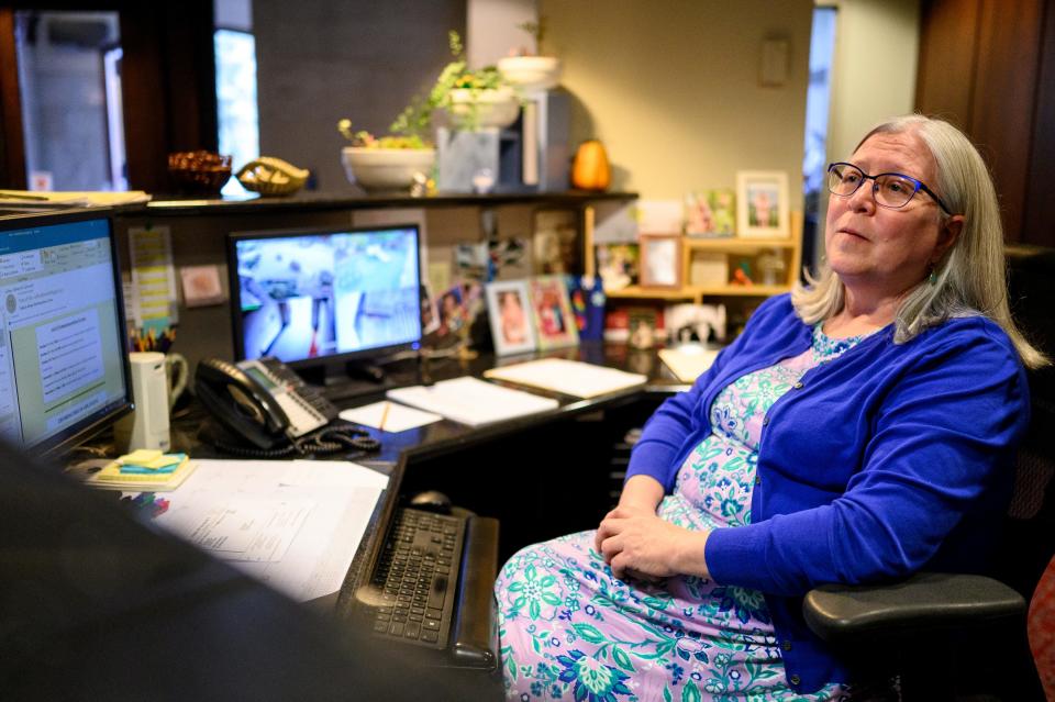 Kim Pieratt, parish administrator of Pittsburgh's Calvary Episcopal Church, sits at her desk at the church on Thursday, Oct. 26, 2023. She has helped welcome congregants from Tree of Life synagogue who have used the church's space for religious services and events after the 2018 shooting.