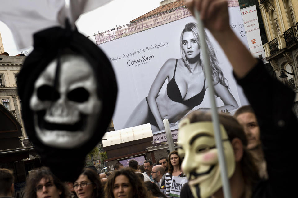 Demonstrators take part in a march to the Spanish Parliament against the austerity measures announced by the Spanish government in Madrid, Spain, Tuesday, Sept. 25, 2012. Spain's government was hit hard by the country's financial crisis on multiple fronts Tuesday as protestors enraged with austerity cutbacks and tax hikes clashed with police near Parliament, a separatist-minded region set elections seen as an independence referendum and the nation's high borrowing costs rose again. (AP Photo/Daniel Ochoa De Olza)