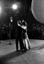 President and Mrs. Carter wave from the stage of the Visitor's Center in Washington where one of the seven inaugural balls was held, Thursday night, January 20, 1977. (AP Photo/stf)