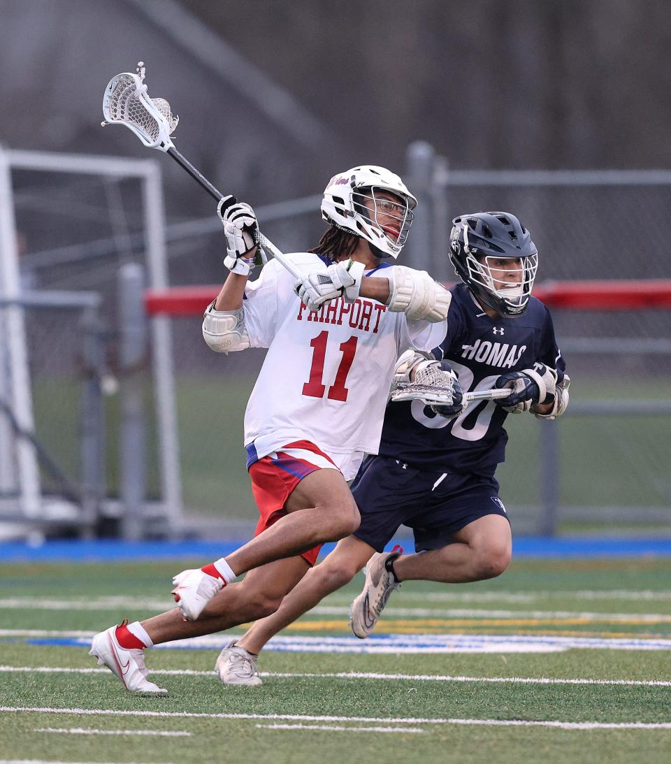 Fairport’s Robert Cameron looks to shoot against Webster Thomas and midfielder Jake Polizzi. 